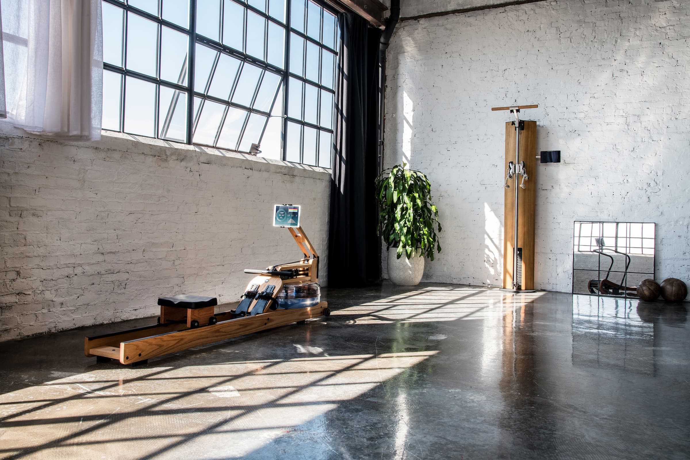 NOHrD SlimBeam Cable Fitness Machine and WaterRower Ergatta Performance Rower in custom gym